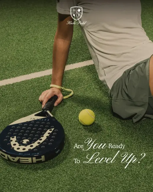 A player resting on court with racket and ball
