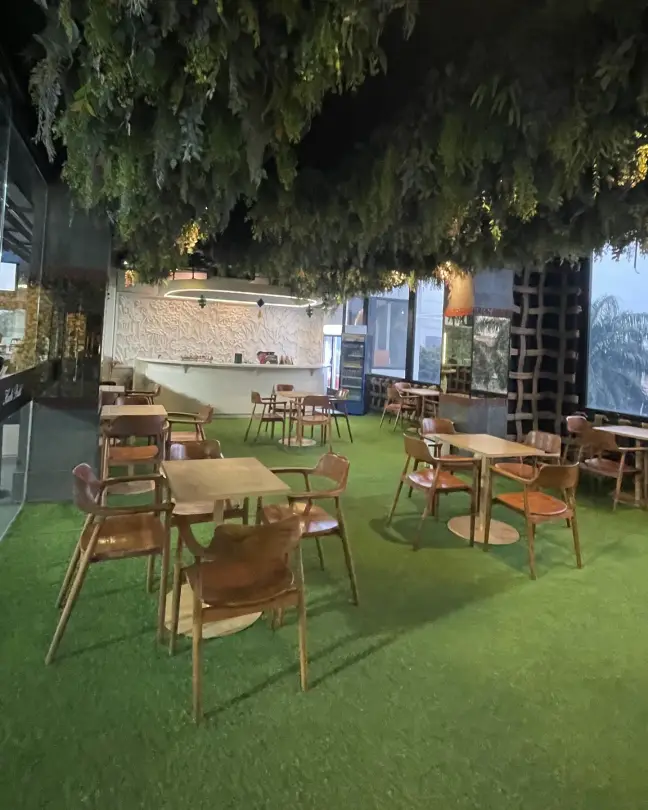Lounge tables under a canopy of hanging plants
