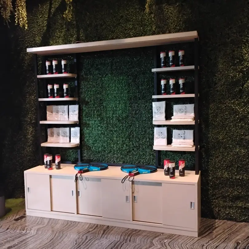 Shop shelves on a green wall